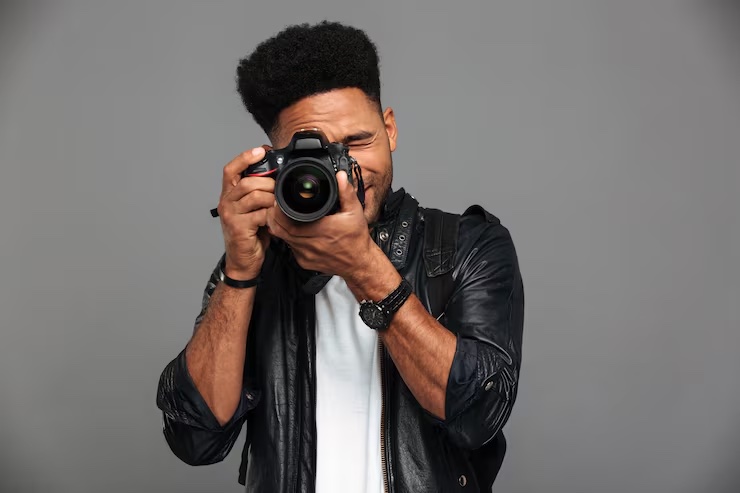 Professional photographer holding a camera, ready to capture your session